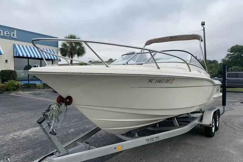 Slide: The Image of 2018 Scout 225 Dorado boat on trailer in parking lot. - 8