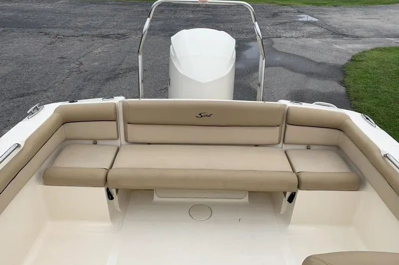 Slide: The Image of 2018 Scout 225 Dorado boat with beige seating and outboard motor. - 9