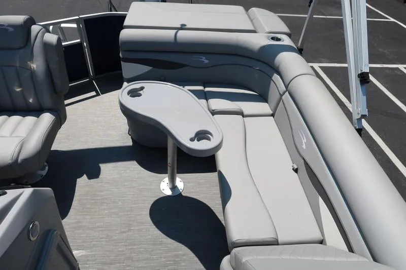 Slide: The Image of 2022 Bennington 20 SLM pontoon boat interior with gray seating and table. - 10