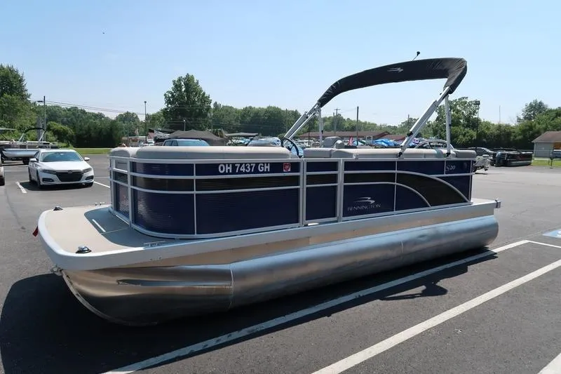 Slide: The Image of 2022 Bennington 20 SLM pontoon boat parked in a lot on a sunny day. - 7
