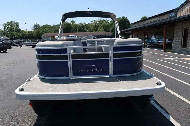 Slide: The Image of 2022 Bennington 20 SLM pontoon boat parked in a lot, rear view. - 8