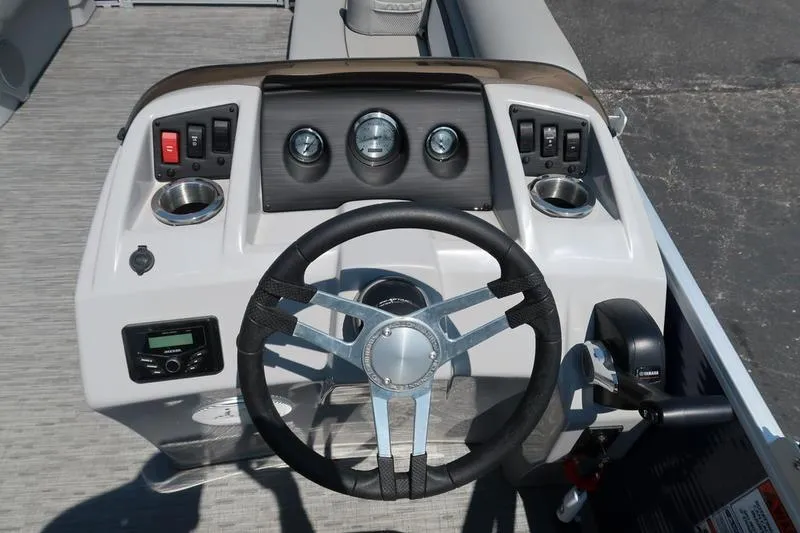 Slide: The Image of 2022 Bennington 20 SLM boat dashboard with steering wheel and control panel. - 9