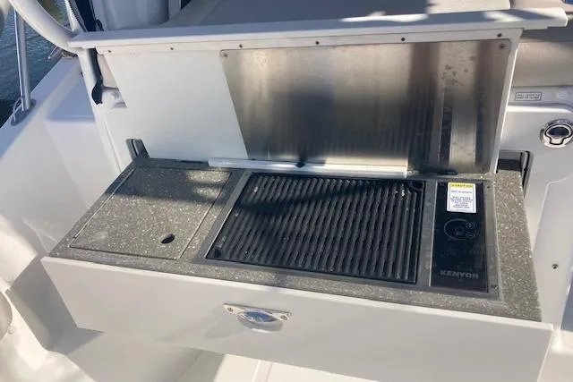 Slide: The Image of Outdoor grill on 2016 Boston Whaler 315 Conquest boat, featuring Kenyon electric cooktop. - 10