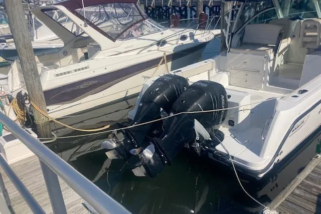 Slide: The Image of 2016 Boston Whaler 315 Conquest docked with dual outboard engines. - 3