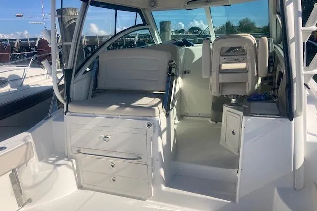 Slide: The Image of 2016 Boston Whaler 315 Conquest interior with seating and storage compartments. - 4