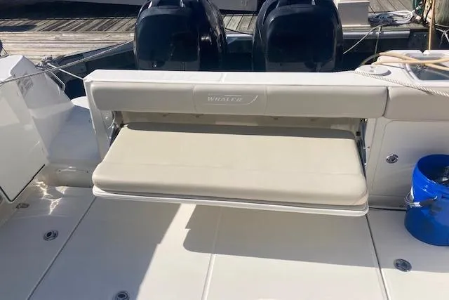 Slide: The Image of 2016 Boston Whaler 315 Conquest boat with foldable seating and dual engines. - 9
