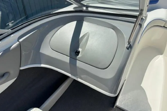 Slide: The Image of 2006 Bayliner 185 Bowrider interior showing storage compartment and seating area. - 11