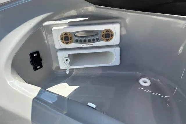 Slide: The Image of 2006 Bayliner 185 Bowrider interior with built-in stereo system and storage compartment. - 12