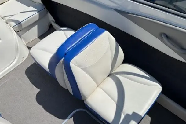 Slide: The Image of 2006 Bayliner 185 Bowrider interior with blue and white seating. - 13