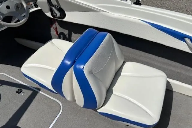Slide: The Image of 2006 Bayliner 185 Bowrider interior with blue and white seating. - 18