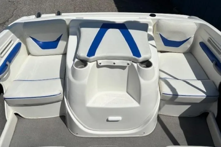 Slide: The Image of 2006 Bayliner 185 Bowrider interior with white and blue seating arrangement. - 23