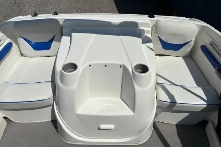Slide: The Image of 2006 Bayliner 185 Bowrider interior with white seating and blue accents. - 24