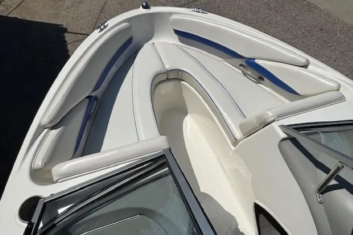 Slide: The Image of 2006 Bayliner 185 Bowrider boat interior with white and blue seating. - 8