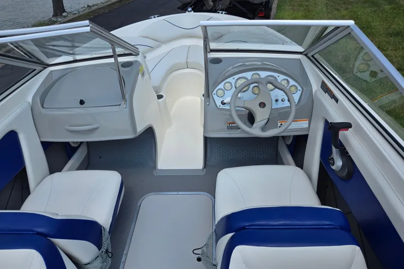 Slide: The Image of 2006 Bayliner 195 Classic boat interior with steering wheel and seating. - 11