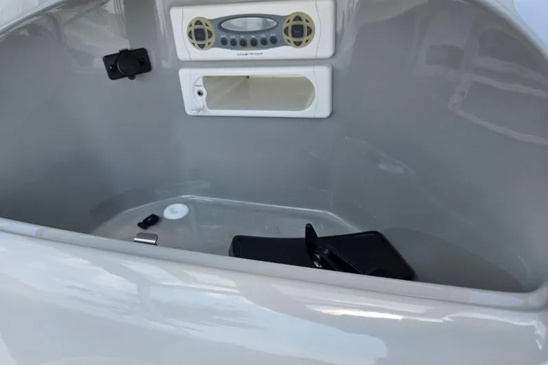 Slide: The Image of 2006 Bayliner 195 Classic boat interior with stereo system and storage compartment. - 15