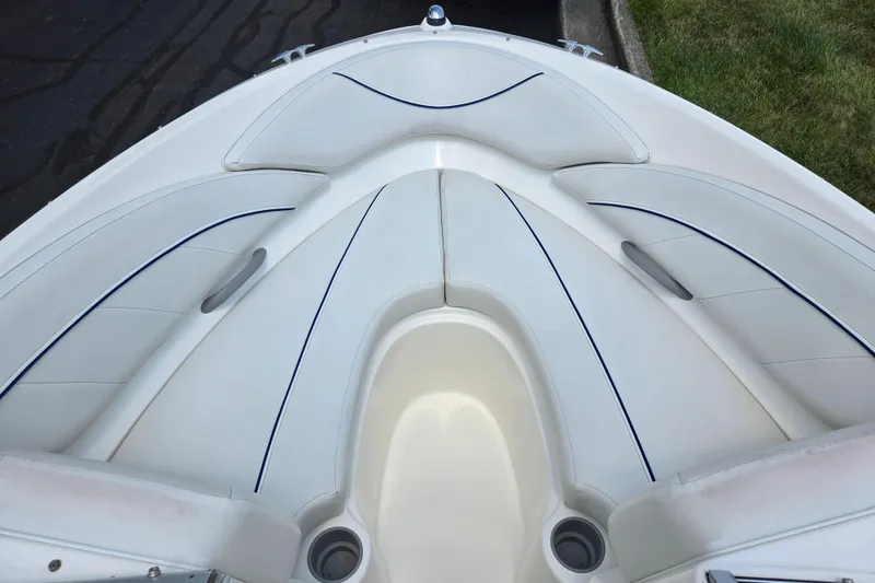 Slide: The Image of 2006 Bayliner 195 Classic boat interior with white seating and blue accents. - 17