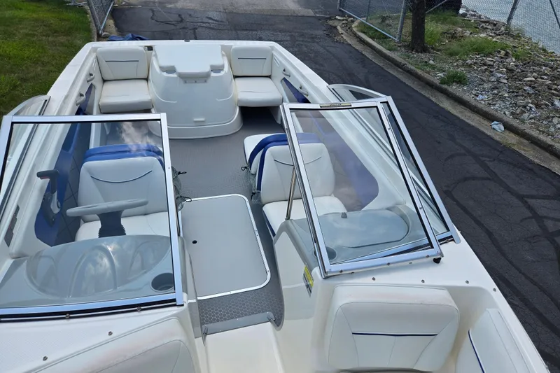 Slide: The Image of 2006 Bayliner 195 Classic boat interior with seating and open windshield. - 19
