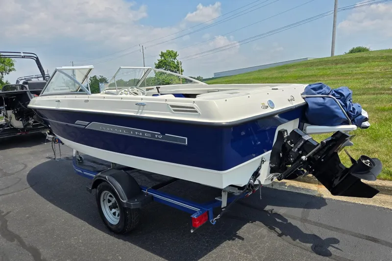 Slide: The Image of 2006 Bayliner 195 Classic boat on trailer, parked outdoors on a sunny day. - 3
