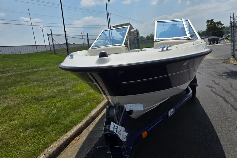 Slide: The Image of 2006 Bayliner 195 Classic boat on trailer, parked outdoors on a sunny day. - 6