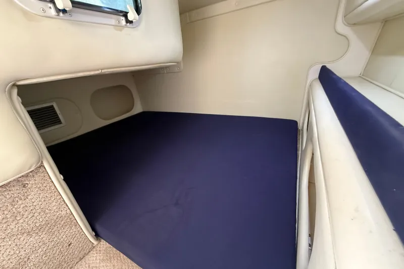 Slide: The Image of Interior cabin of 2000 Rinker 270 Fiesta Vee with blue mattress. - 19