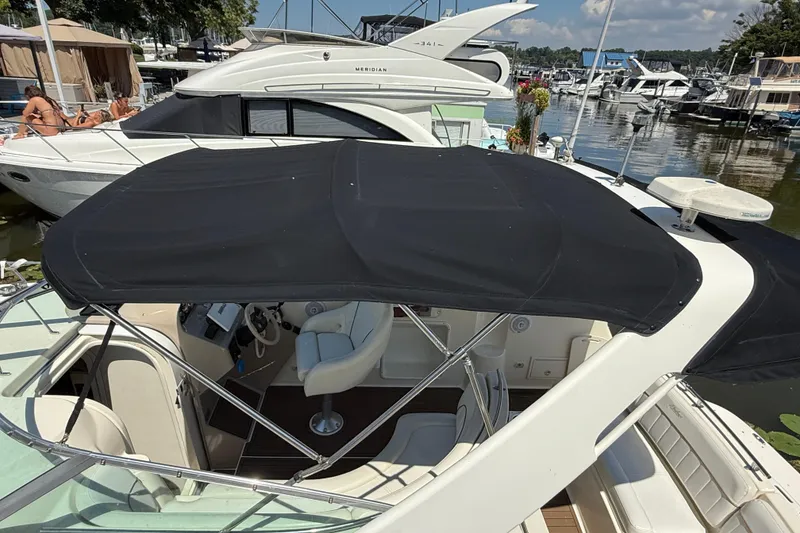 Slide: The Image of 2000 Rinker 270 Fiesta Vee boat docked at marina with black canopy. - 4