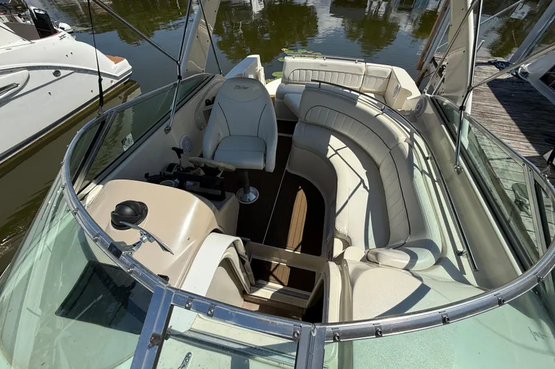 Slide: The Image of 2000 Rinker 270 Fiesta Vee boat interior with white seating and helm. - 5