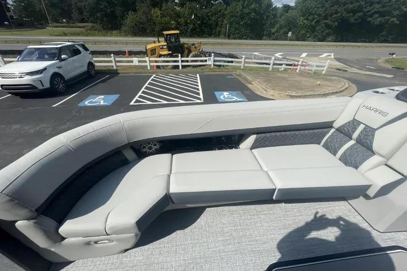 Slide: The Image of 2026 Harris Grand Mariner 250 boat interior with luxurious seating in a parking lot. - 12