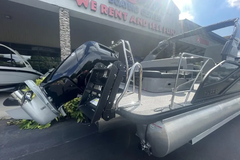 Slide: The Image of 2026 Harris Grand Mariner 250 pontoon boat displayed at a rental center. - 2