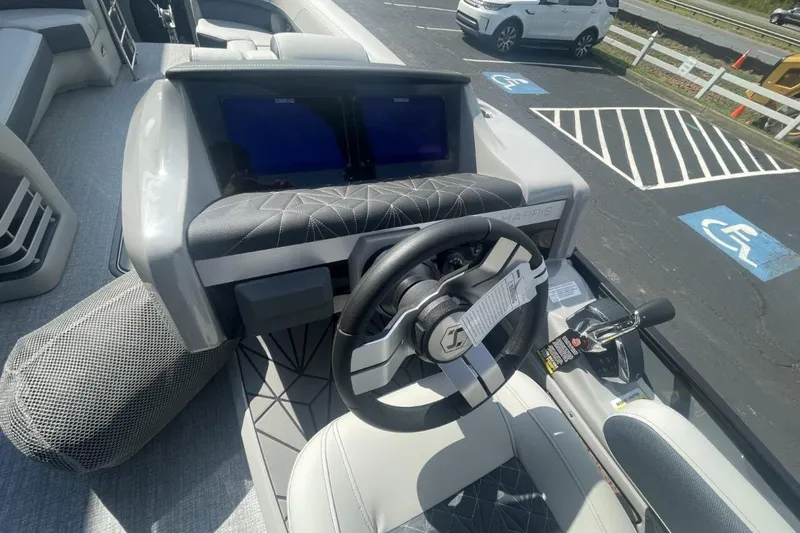 Slide: The Image of 2026 Harris Grand Mariner 250 boat dashboard with steering wheel and control panel. - 4