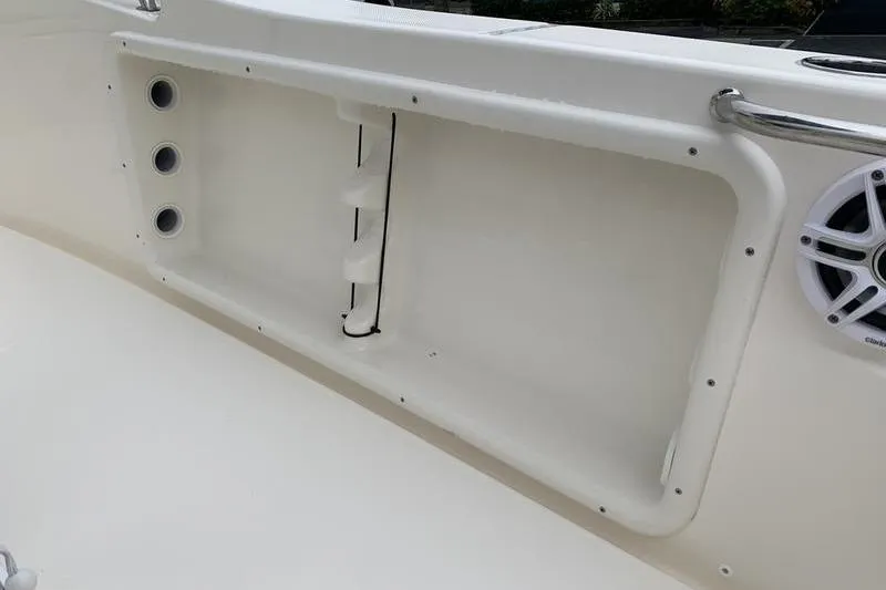Slide: The Image of 2025 Bulls Bay 200CC boat interior with storage compartment and speaker. - 14
