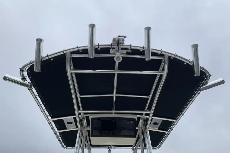 Slide: The Image of T-top of 2025 Bulls Bay 200CC boat with rod holders against cloudy sky. - 16