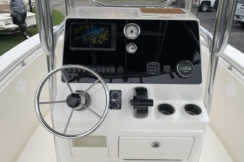 Slide: The Image of 2025 Bulls Bay 200CC boat console with steering wheel, gauges, and navigation display. - 18