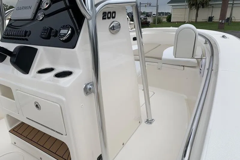 Slide: The Image of 2025 Bulls Bay 200CC boat interior with Garmin dashboard and seating area. - 22