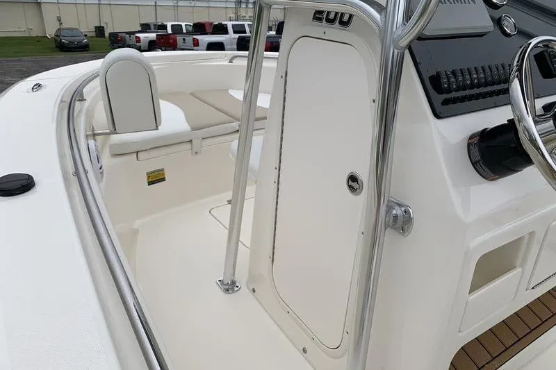 Slide: The Image of 2025 Bulls Bay 200CC boat interior with steering console and seating area. - 23