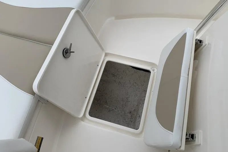 Slide: The Image of 2025 Bulls Bay 200CC boat storage compartment with open hatch and cushioned seat. - 29