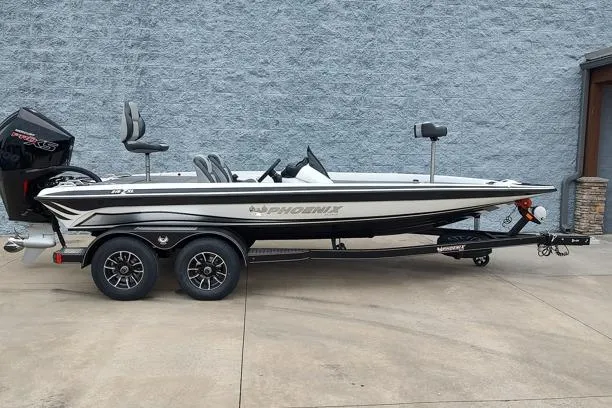 The Image of 2026 Phoenix 819ZXL fishing boat on trailer, side view against gray wall. - 1