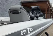 Slide: The Image of 2026 Phoenix 819ZXL boat, sleek design, gray seating, modern dashboard, outdoor setting. - 6