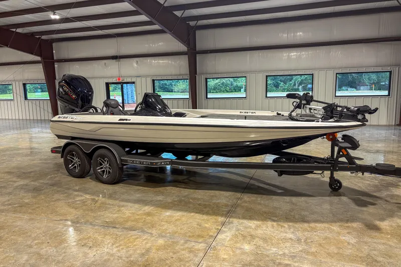 The Image of 2026 Skeeter ZXR 19 boat on trailer in spacious indoor facility. - 1