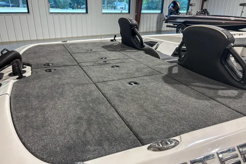 Slide: The Image of 2026 Skeeter ZXR 19 boat interior with carpeted deck and seating. - 6