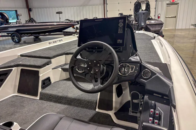 Slide: The Image of Interior of a 2026 Skeeter ZXR 19 boat with steering wheel and control panel. - 7