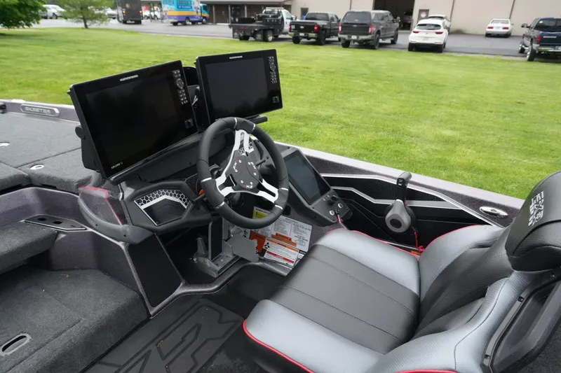 Slide: The Image of 2025 Skeeter FXR20 LE boat cockpit with dual screens and modern steering wheel. - 16