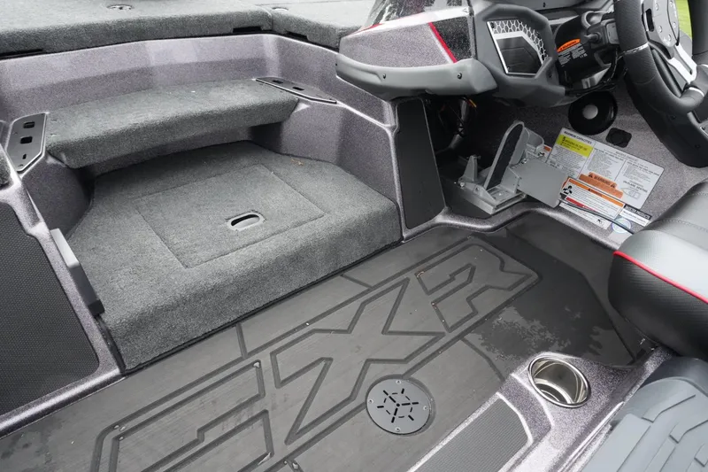 Slide: The Image of 2025 Skeeter FXR20 LE boat interior with carpeted steps and modern dashboard. - 17