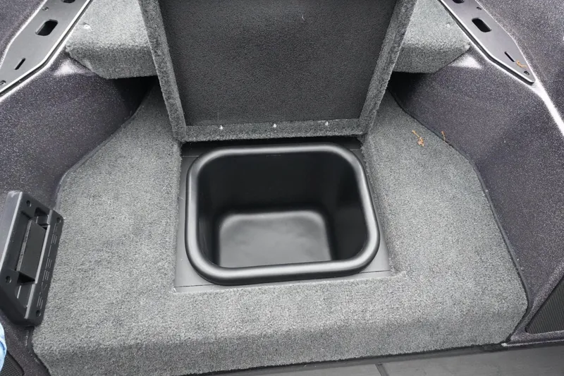 Slide: The Image of 2025 Skeeter FXR20 LE boat storage compartment with carpeted interior. - 19