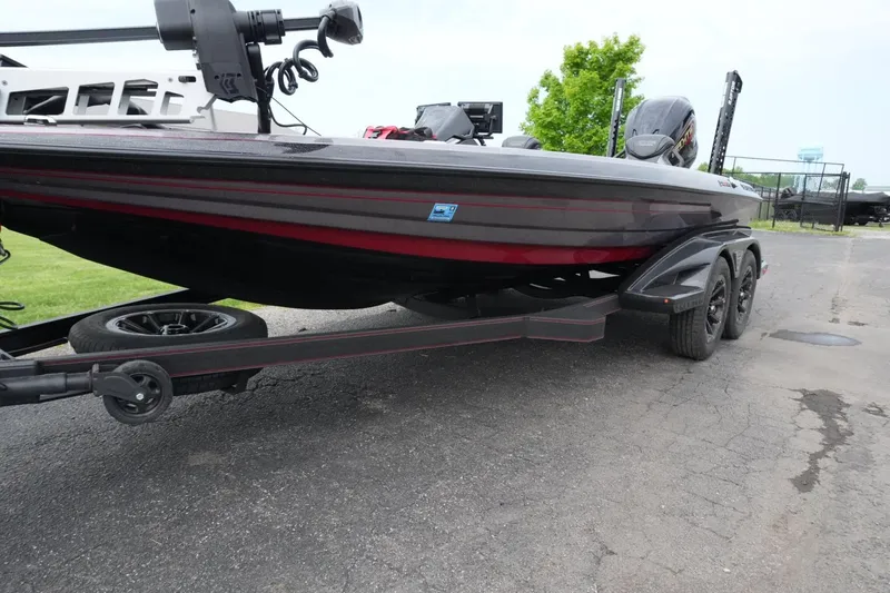 Slide: The Image of 2025 Skeeter FXR20 LE boat on trailer, parked outdoors. - 20