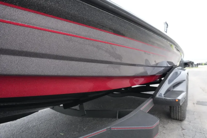 Slide: The Image of 2025 Skeeter FXR20 LE boat with sleek red and black design on trailer. - 21