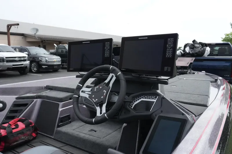 Slide: The Image of 2025 Skeeter FXR20 LE boat dashboard with dual monitors and steering wheel. - 7