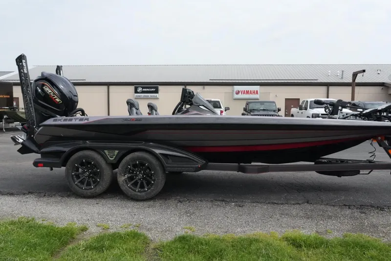 Slide: The Image of 2025 Skeeter FXR20 LE bass boat on trailer, parked outside dealership. - 9