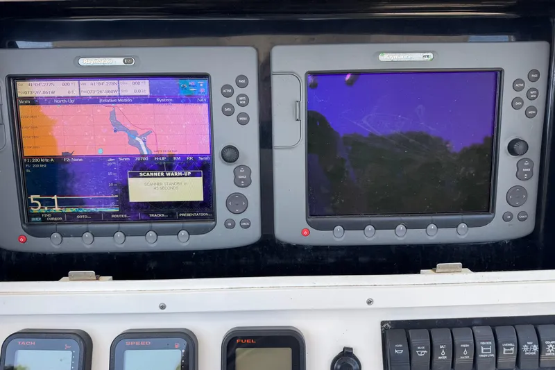 Slide: The Image of 2008 Regulator 26 Forward Seating boat dashboard with navigation screens and controls. - 10