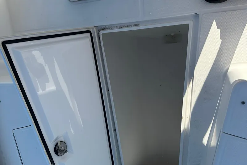 Slide: The Image of Open storage compartment on a 2008 Regulator 26 Forward Seating boat. - 13
