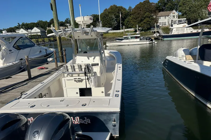 Slide: The Image of 2008 Regulator 26 Forward Seating boat docked in a marina, surrounded by other boats. - 14